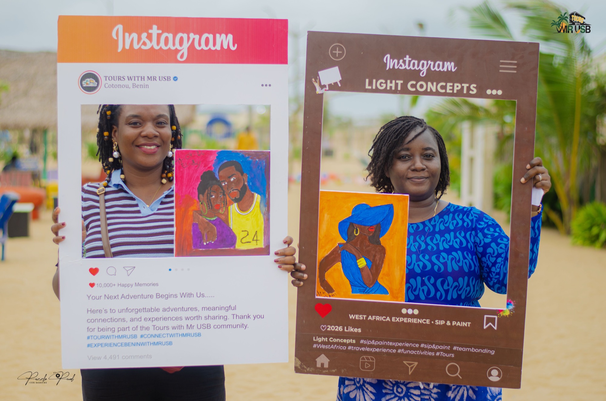 Friends holding photo frames and the colourful canvases they painted